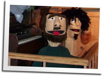 The logging skid camp features an old timey puppet theatre